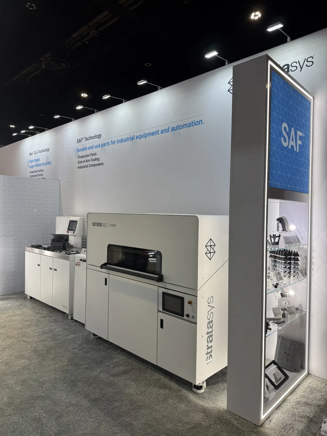 Stratasys H350 SAF production printer and parts display case on the Stratasys exhibition stand at IMTS 2026 in Chicago